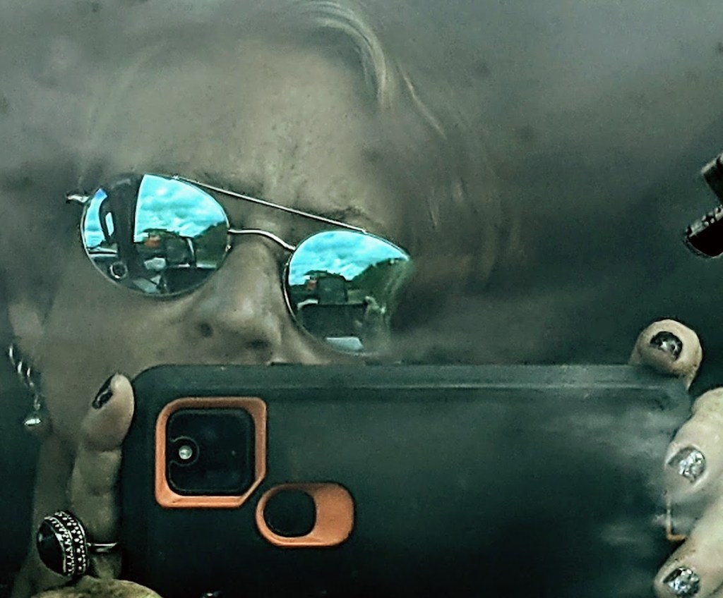 Megan taking a photo on the 2021 road trip from Colorado Springs, CO to Boston, MA.